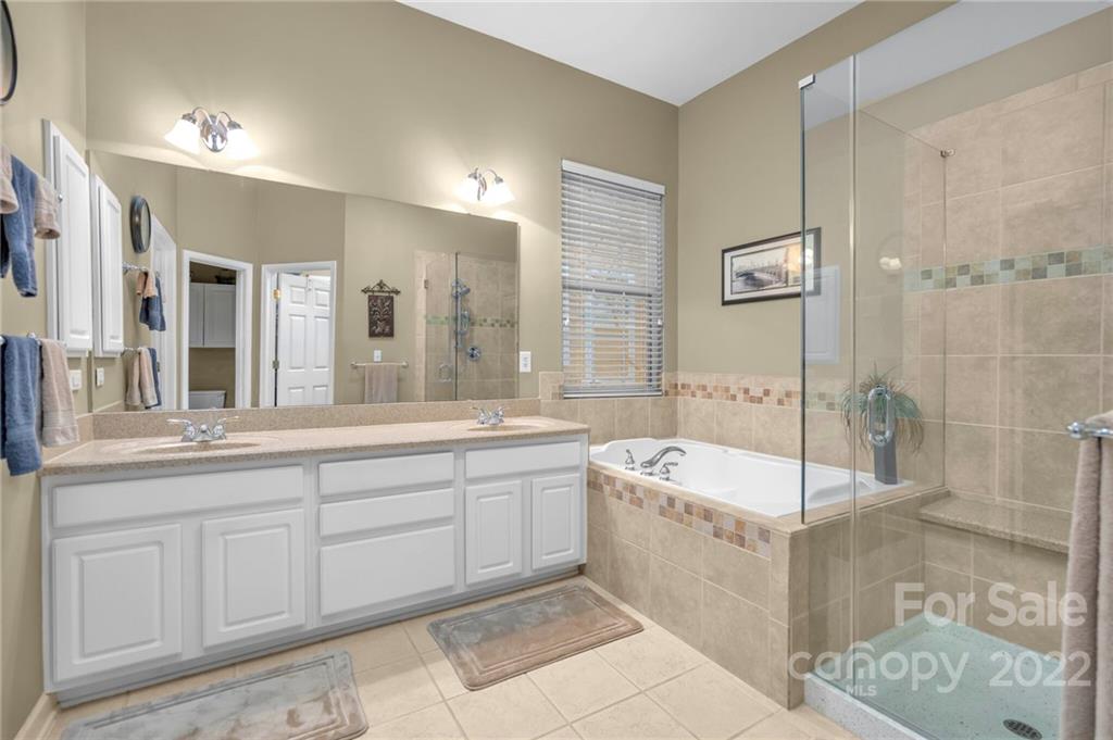 17018 Carlton Way Road Huntersville, NC 28078 - Photo 32 of 42 a spacious bathroom with a tub sink shower and mirror
