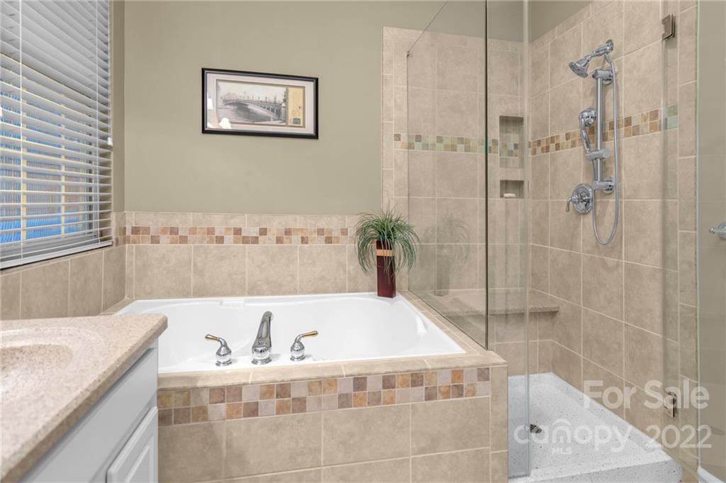 17018 Carlton Way Road Huntersville, NC 28078 - Photo 33 of 42 a bathroom with a bathtub and a shower