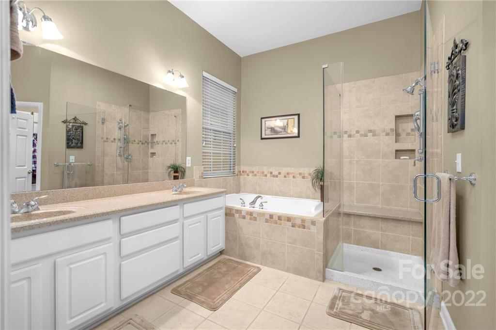 17018 Carlton Way Road Huntersville, NC 28078 - Photo 35 of 42 a bathroom with a granite countertop bathtub shower sink and mirror