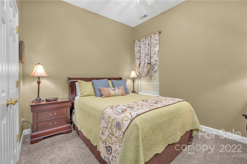 17018 Carlton Way Road Huntersville, NC 28078 - Photo 37 of 42 a bedroom with a bed and a lamp