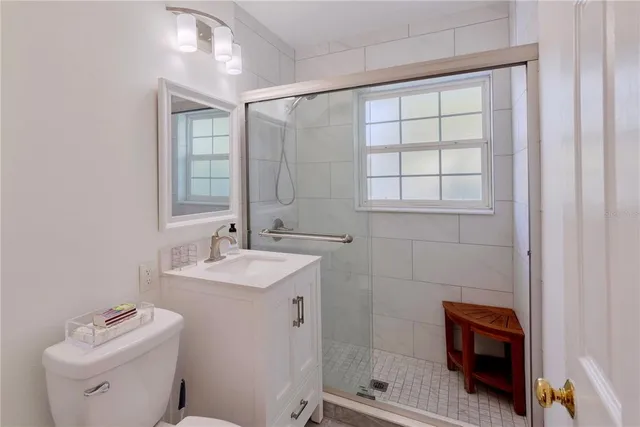 a street sign on a wall next to road