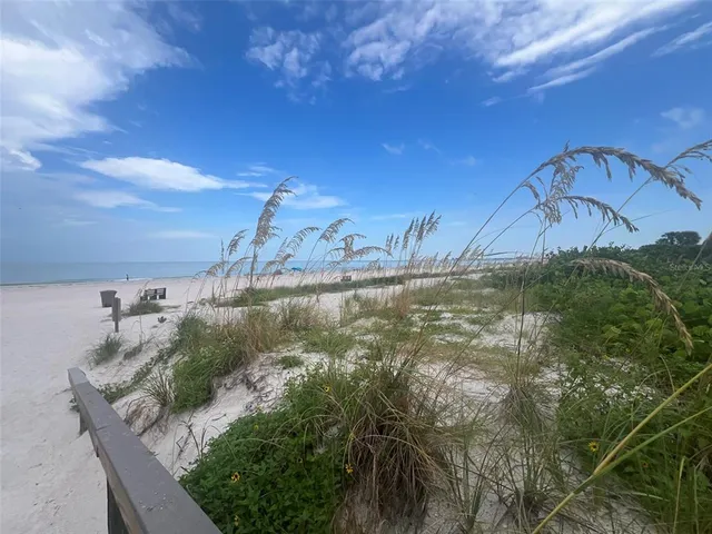 a yellow house with trees in front of it