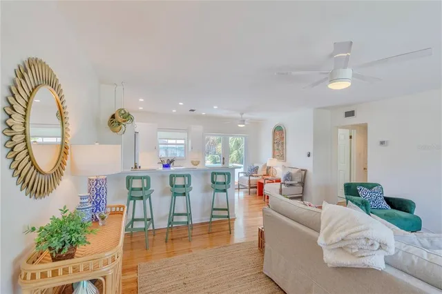 a living room with furniture a dining table with wooden floor