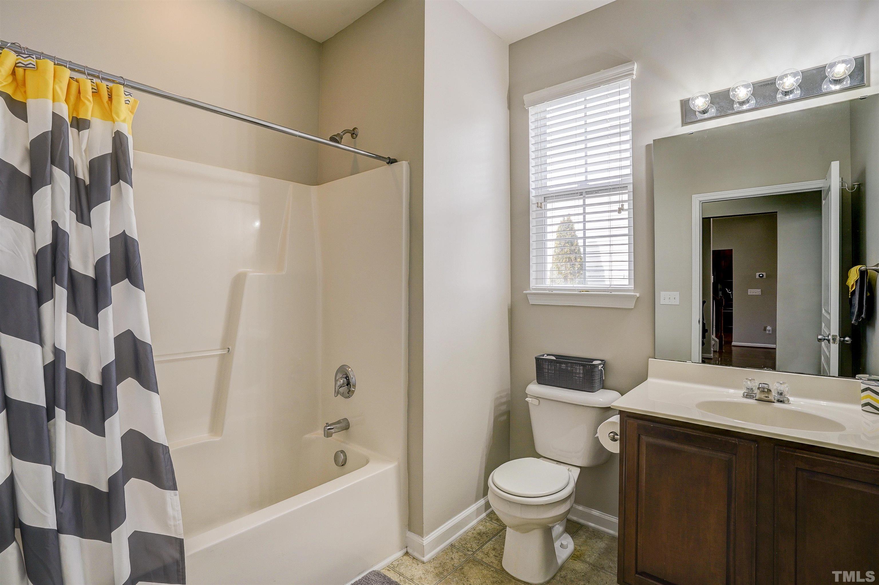 301 Cottesbrook Drive Wake Forest, NC 27587 - Photo 18 of 32 a bathroom with a sink and a mirror