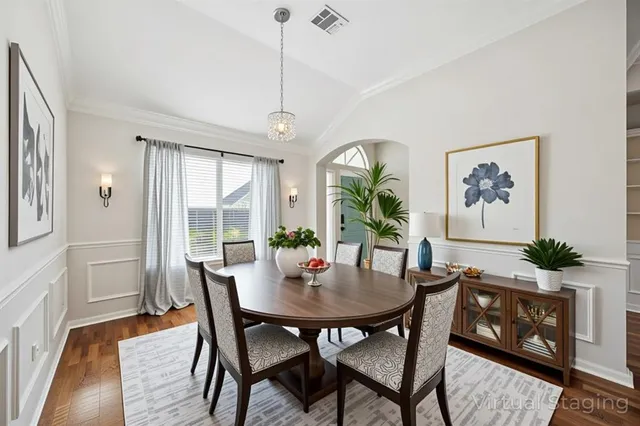 a view of a dining room with furniture window and wooden floor