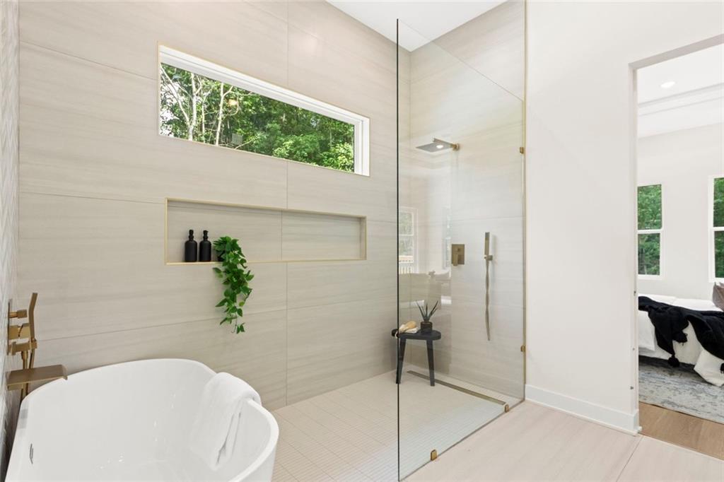 7066 Bells Way Fairburn, GA 30213 - Photo 35 of 64 a bathroom with a toilet and a shower