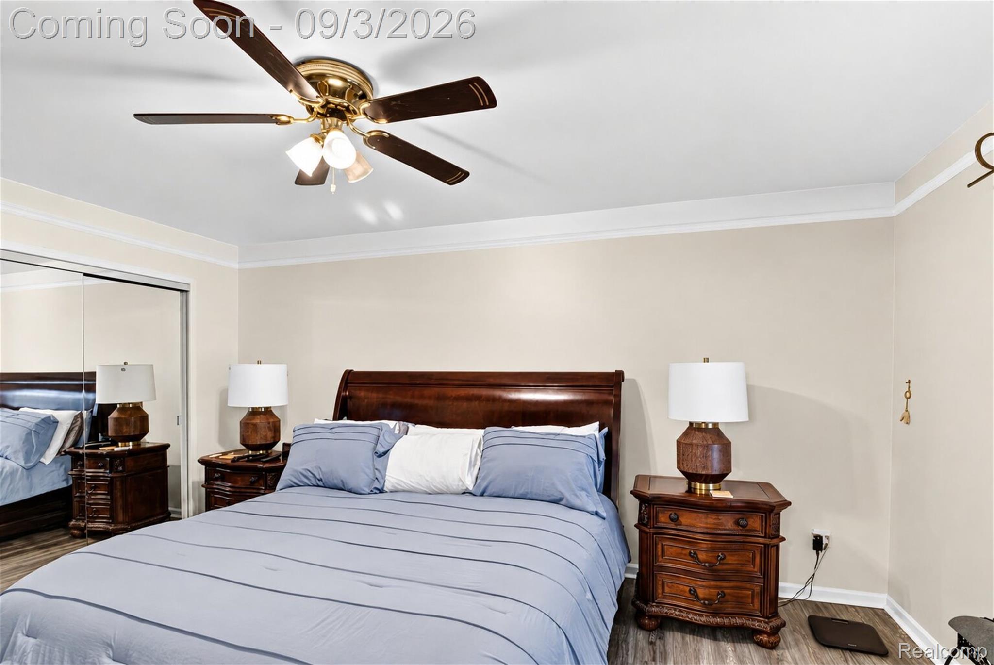 27260 Campbell Road Warren, MI 48093 - Photo 23 of 60 Ceiling fan with integrated lighting, wood-finish flooring, mirrored closet doors, and crown molding