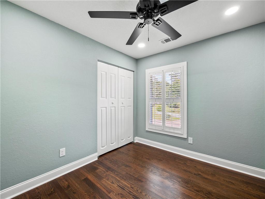 5209 Byers Road Gainesville, GA 30504 - Photo 21 of 34 an empty room with wooden floor chandelier fan and windows