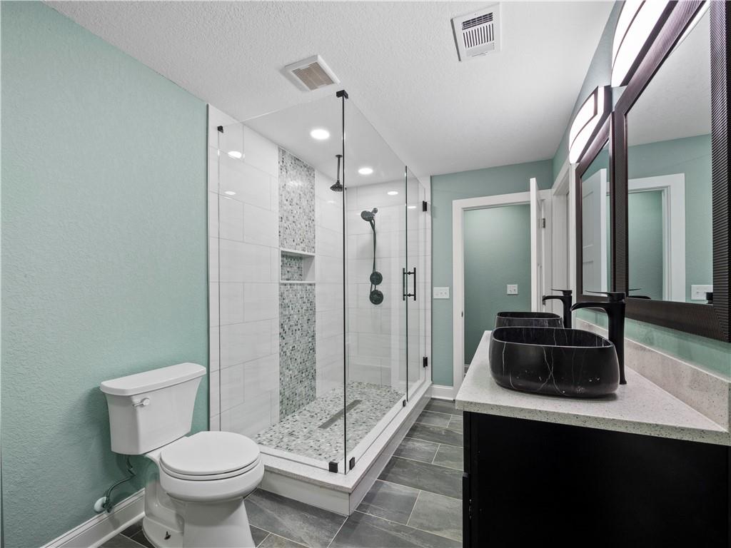 5209 Byers Road Gainesville, GA 30504 - Photo 27 of 34 a bathroom with a sink a toilet and shower