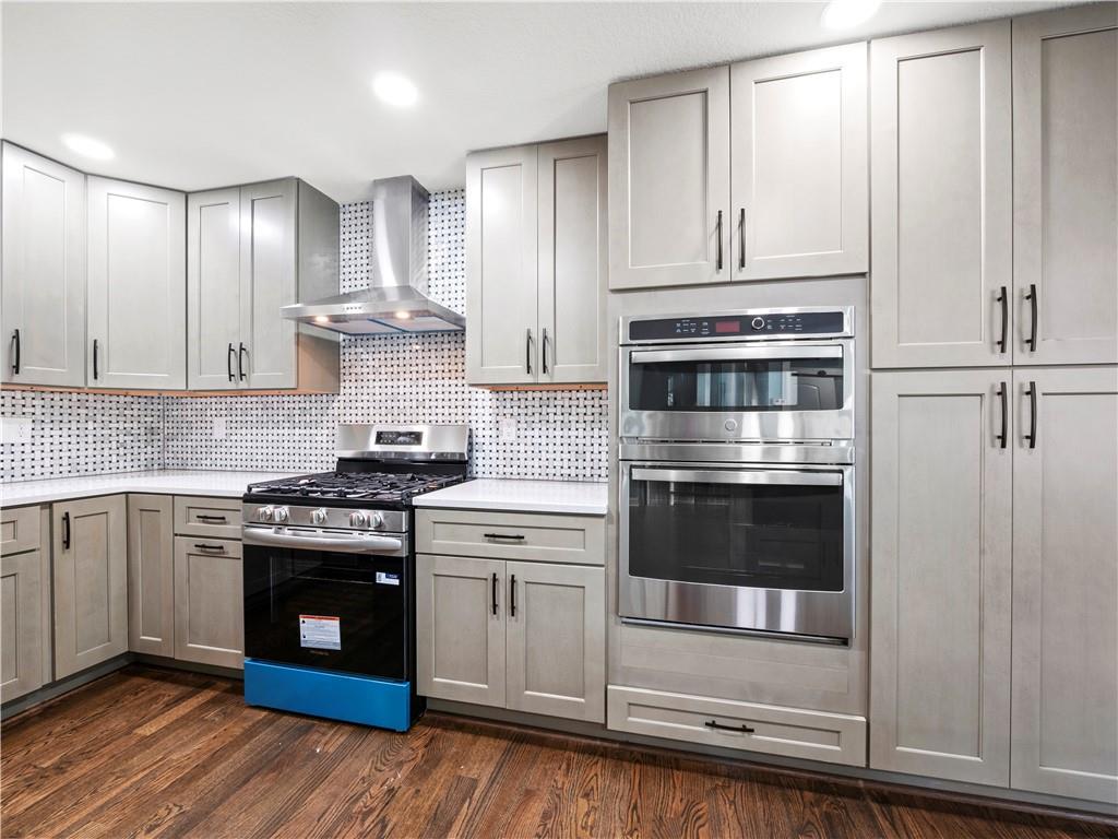 5209 Byers Road Gainesville, GA 30504 - Photo 4 of 34 a kitchen with stainless steel appliances granite countertop a stove and a refrigerator