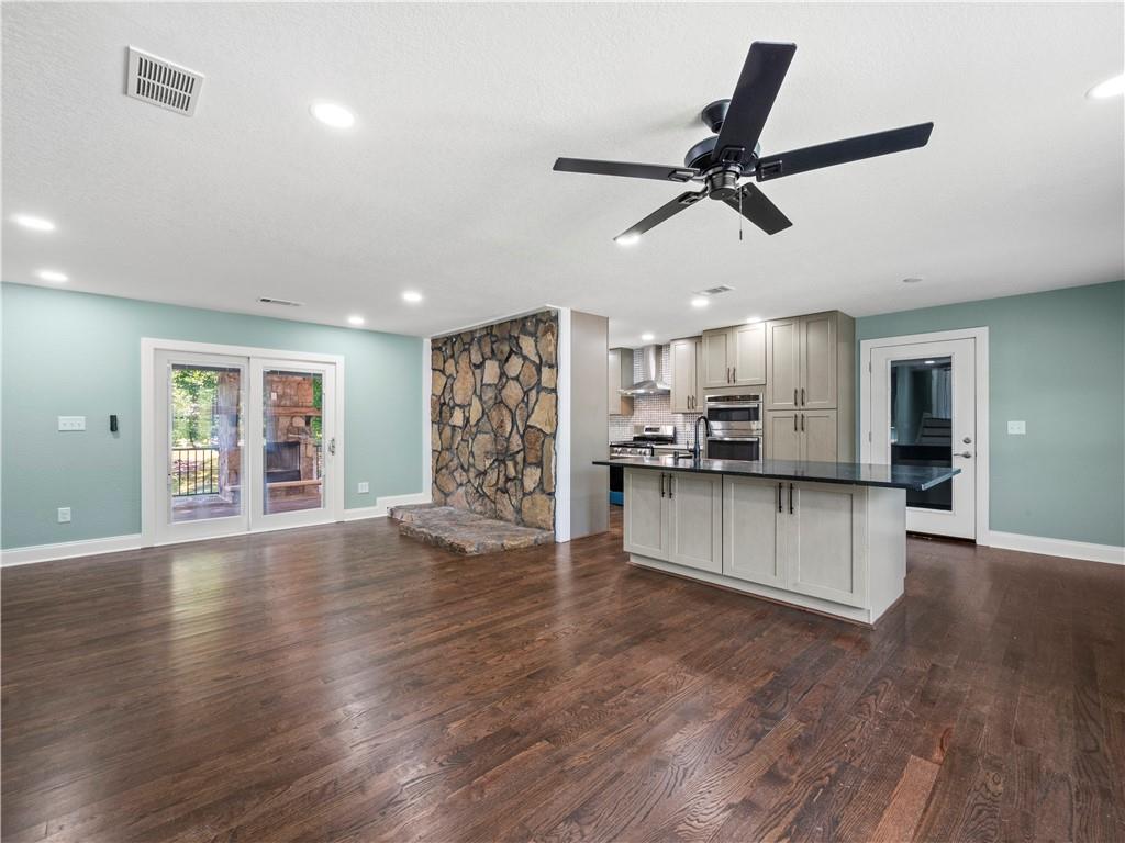 5209 Byers Road Gainesville, GA 30504 - Photo 8 of 34 a living room with stainless steel appliances kitchen island hardwood floor and a window