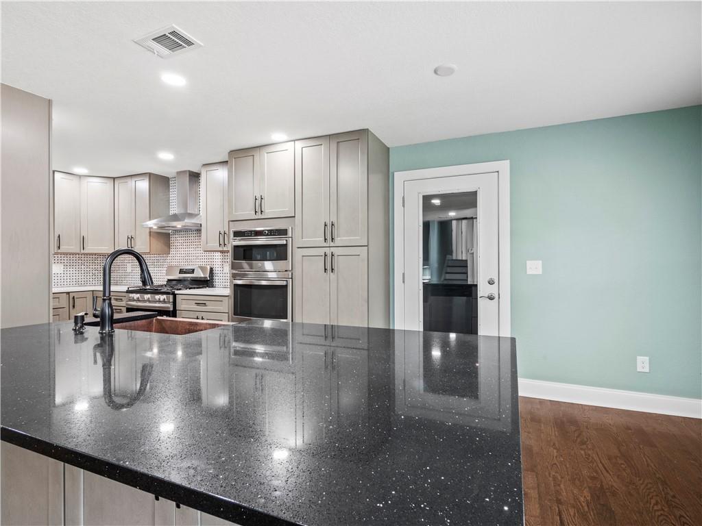 5209 Byers Road Gainesville, GA 30504 - Photo 9 of 34 a view of a kitchen with kitchen island a sink stainless steel appliances and cabinets