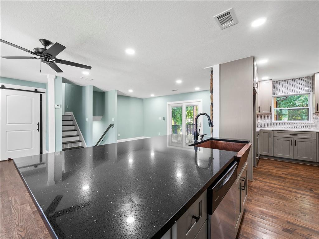 5209 Byers Road Gainesville, GA 30504 - Photo 10 of 34 a large kitchen with stainless steel appliances a table chairs and wooden floor