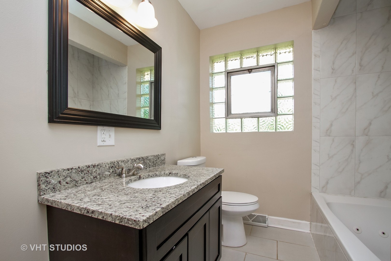 1008 Braemar Road Flossmoor, IL 60422 - Photo 9 of 10 a bathroom with a granite countertop sink a toilet and a bathtub