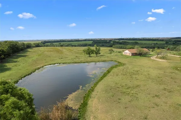 a view of a lake with a yard