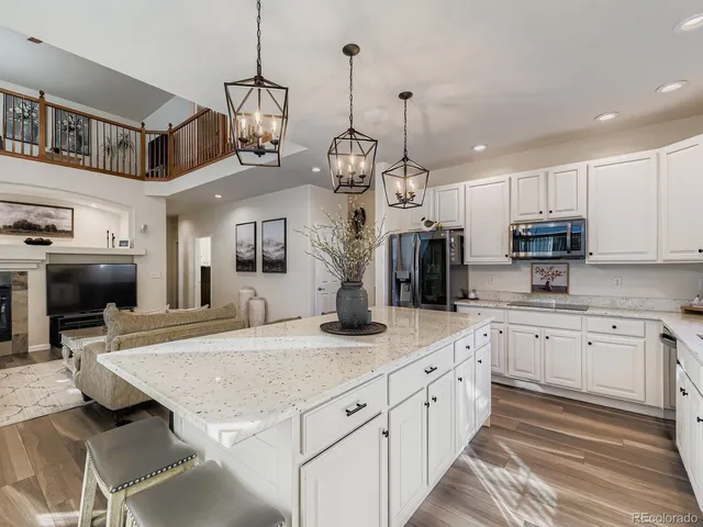 a kitchen with stainless steel appliances granite countertop a stove and cabinets