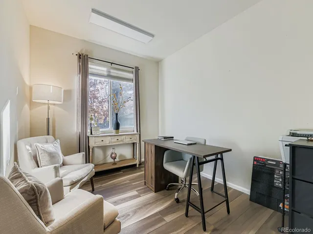 a living room with furniture a window and a flat screen tv