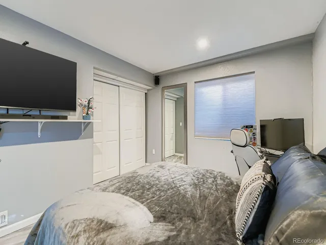a bedroom with a bed and a flat screen tv