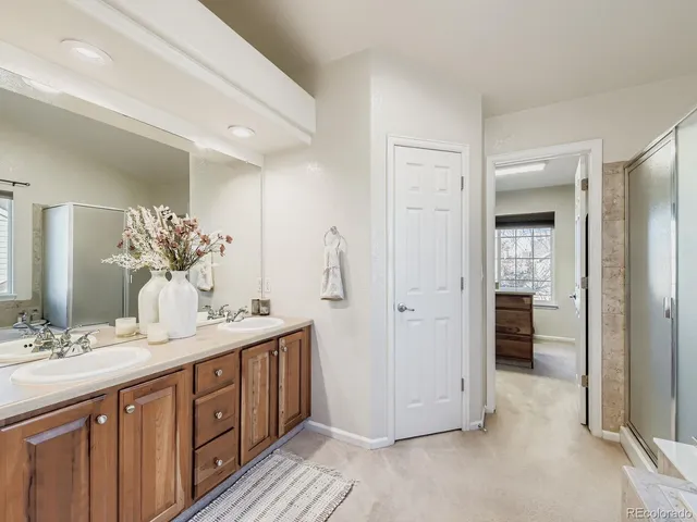 a spacious bathroom with a double vanity sink and a mirror