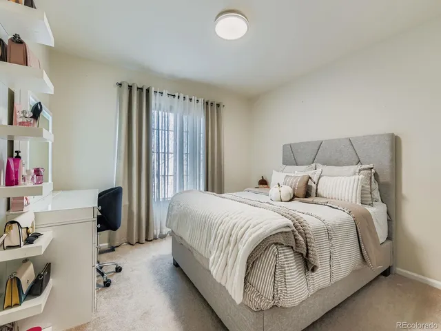 a bedroom with a bed and a large window