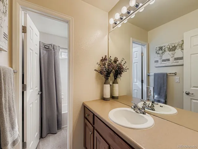 a bathroom with a granite countertop sink and a mirror