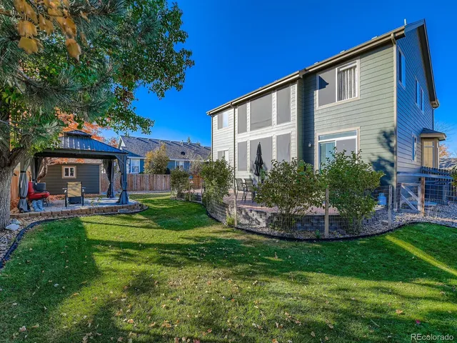 a front view of house with a garden and patio