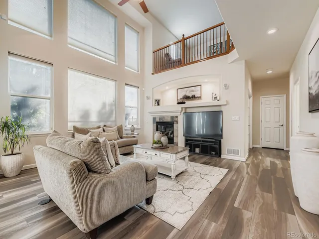 a living room with furniture and a fireplace