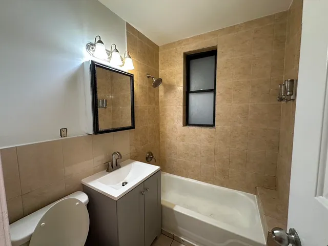 a bathroom with a sink vanity mirror and toilet
