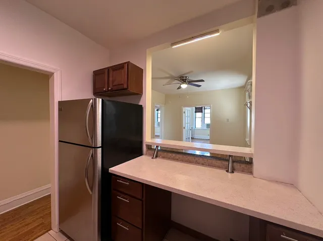 a kitchen with a refrigerator and a sink