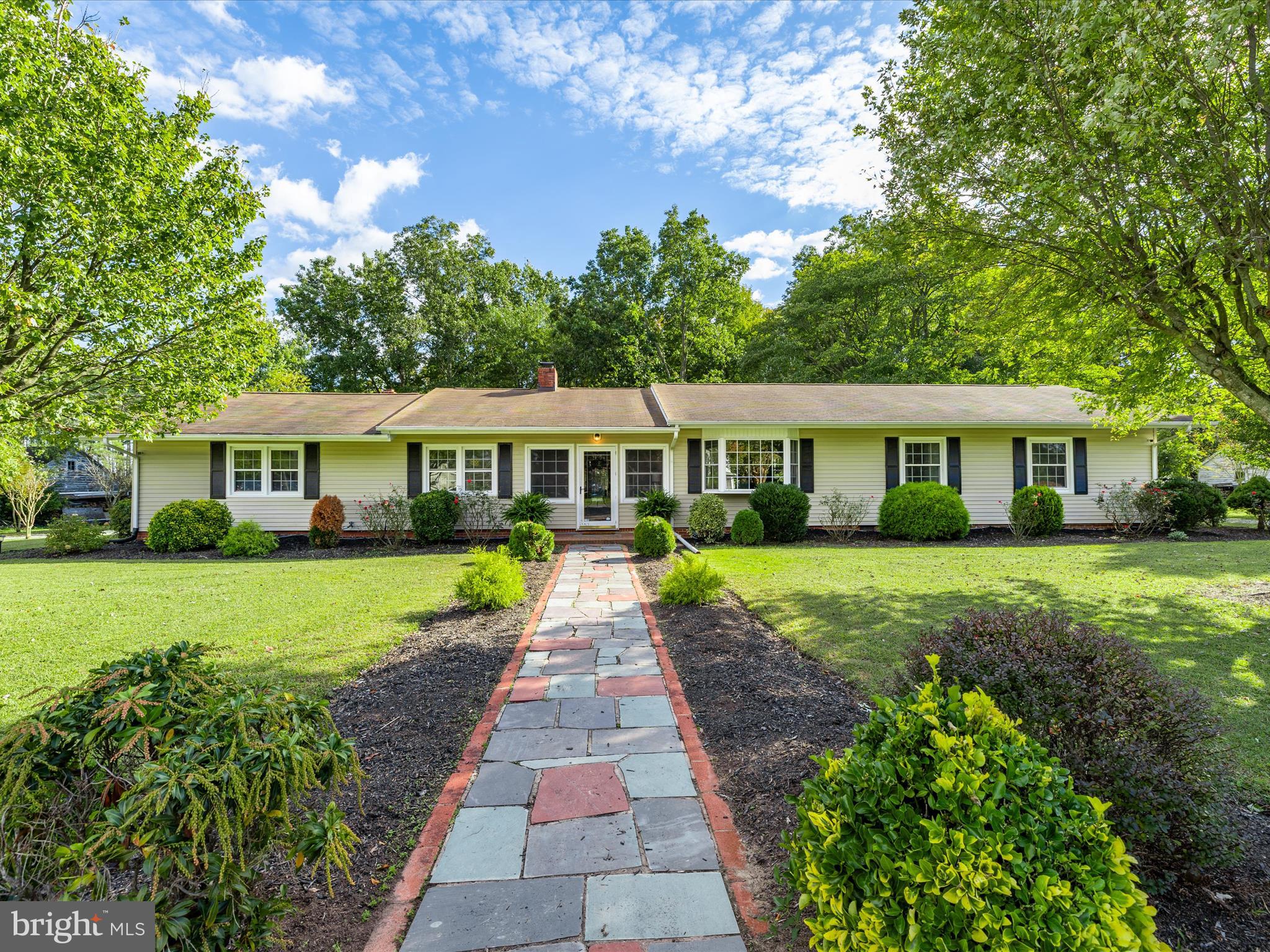 26905 Mt Vernon Road Princess Anne, MD 21853 - Photo 2 of 74 a front view of a house with a garden