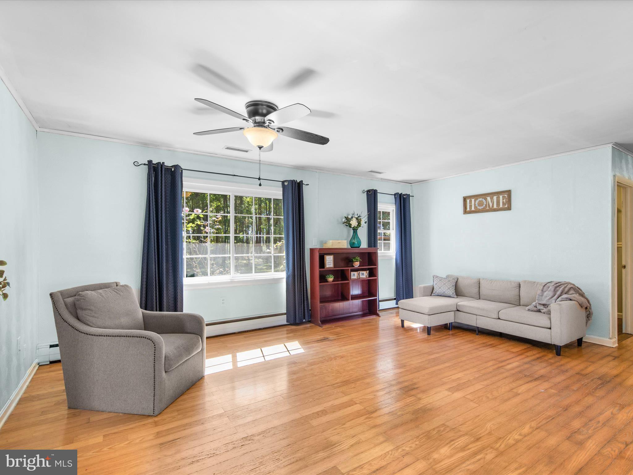 26905 Mt Vernon Road Princess Anne, MD 21853 - Photo 25 of 74 a living room with furniture and a large window