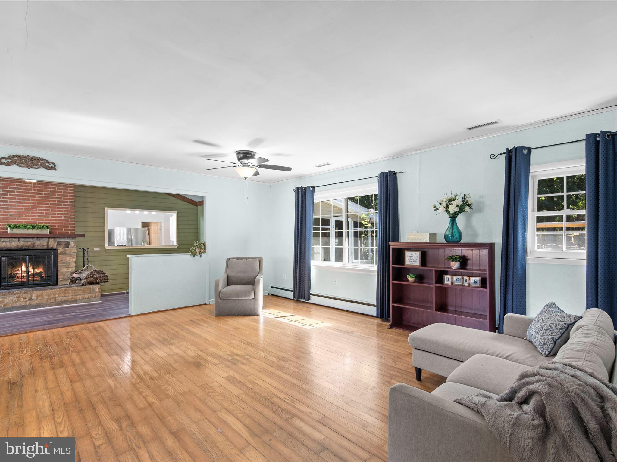 26905 Mt Vernon Road Princess Anne, MD 21853 - Photo 26 of 74 a living room with furniture and a fireplace