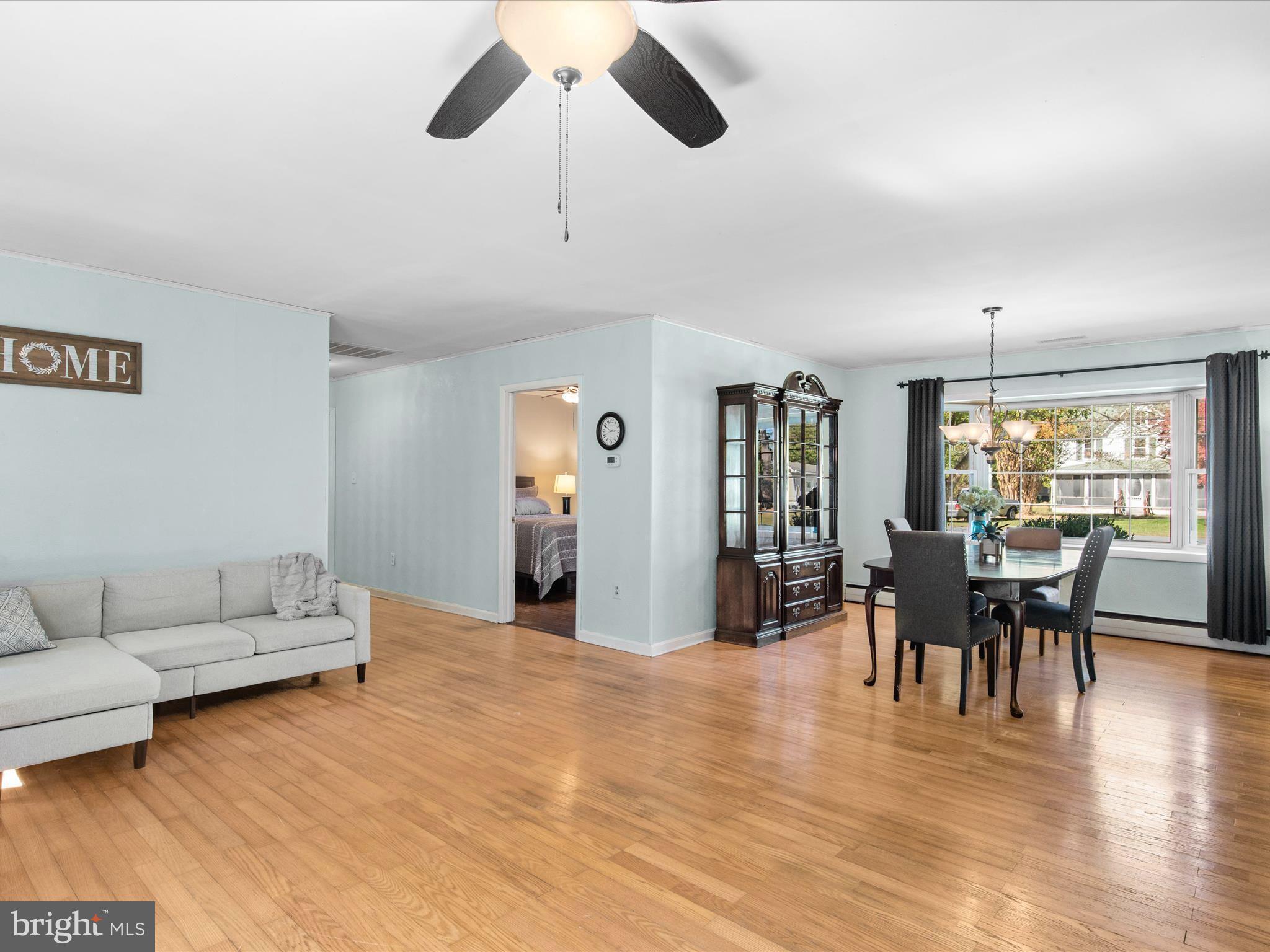 26905 Mt Vernon Road Princess Anne, MD 21853 - Photo 32 of 74 a living room with furniture dining table and a large window