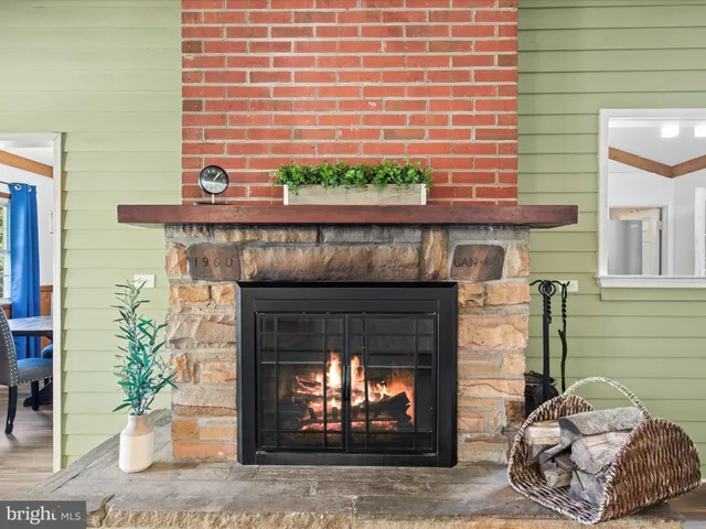 a kitchen with stainless steel appliances a stove a sink a refrigerator white cabinets and wooden floor