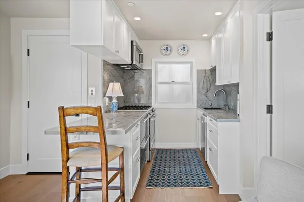 a kitchen with stainless steel appliances granite countertop a refrigerator sink and cabinets