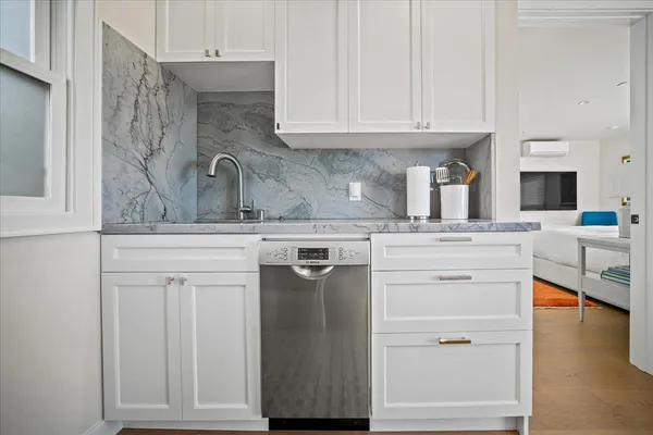 a kitchen with stainless steel appliances granite countertop a sink stove and cabinets