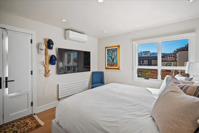 a bedroom with a bed and a large window