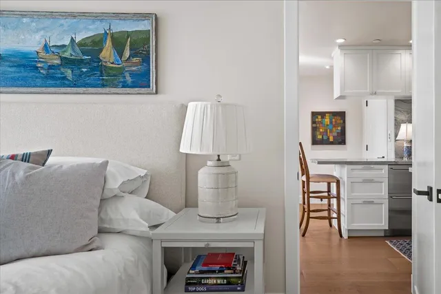 a living room with furniture and a painting on the wall