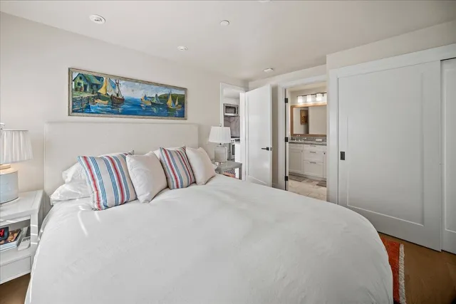 a large white bed in a white room