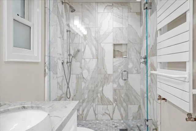 a bathroom with a granite countertop shower and a sink