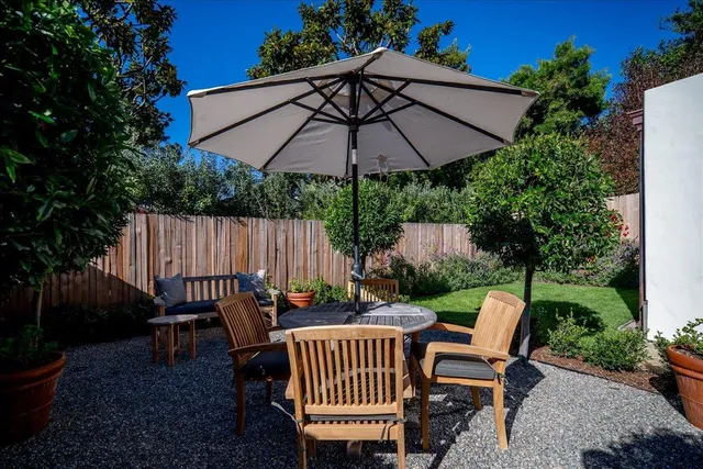 a view of a chair and table in the patio