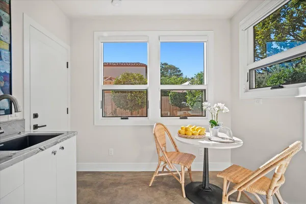 a dining room with furniture and window