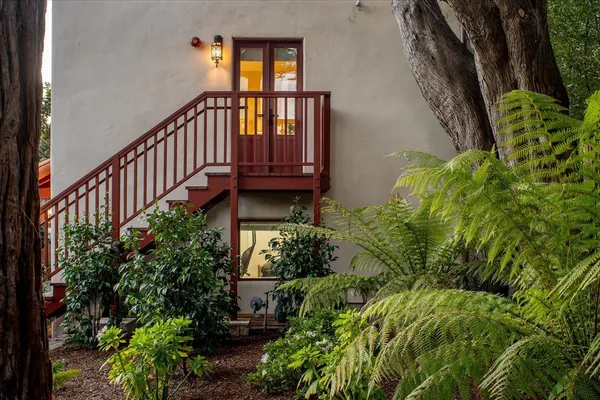 a view of a house with brick walls and flower plants