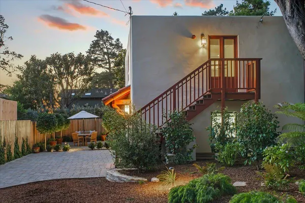 a view of a house with brick walls and flower plants