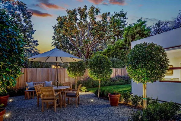 an outdoor space with furniture and umbrella