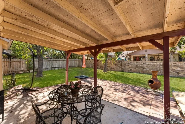 a view of a house with backyard and sitting area