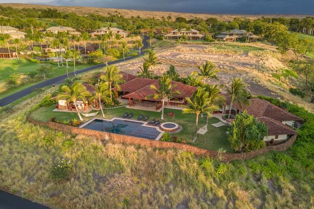 an aerial view of residential houses with outdoor space and swimming pool