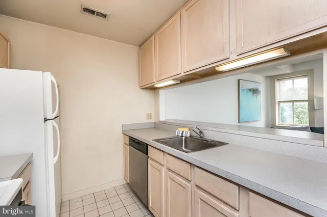 a kitchen with a sink and chairs