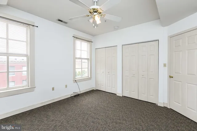 an empty room with a ceiling fan
