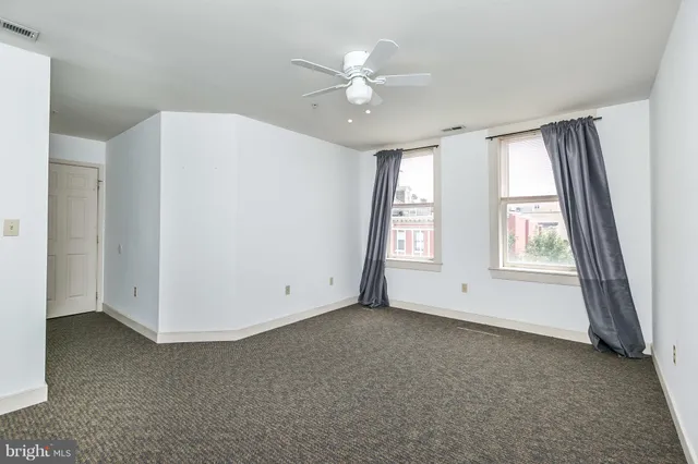 an empty room with a ceiling fan
